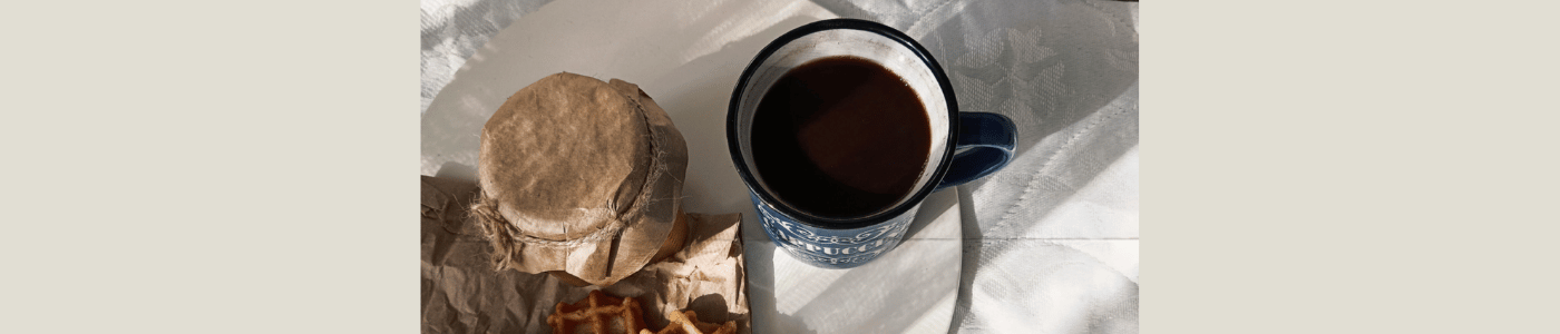 black coffee and apple jam on a lace tablecloth