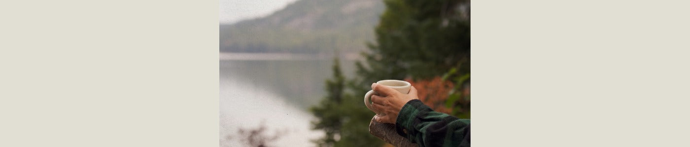 drinking hot coffee looking out over a mountain